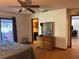 Bedroom featuring a ceiling fan, dresser, and closet at 974 Feather Dr, Deltona, FL 32725