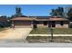 Charming single-story brick home featuring an attached garage and solar panels on the roof at 974 Feather Dr, Deltona, FL 32725
