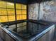 Enclosed hot tub area with galaxy themed wallpaper and a large picture window at 974 Feather Dr, Deltona, FL 32725