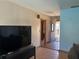 Cozy living room with neutral walls, tiled floors, and a view of the front door at 974 Feather Dr, Deltona, FL 32725