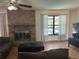 Comfortable living room featuring a brick fireplace and a window view of the outdoor pool at 974 Feather Dr, Deltona, FL 32725