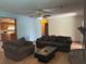 Spacious living room with a ceiling fan, hardwood floors, and open access to the kitchen at 974 Feather Dr, Deltona, FL 32725