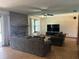 Inviting living room featuring a fireplace, large TV, and comfortable seating area at 974 Feather Dr, Deltona, FL 32725