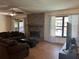 Living room showcasing a fireplace, large TV, and a sliding glass door to the pool area at 974 Feather Dr, Deltona, FL 32725