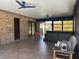 Covered patio with tile flooring, brick walls, and jacuzzi at 974 Feather Dr, Deltona, FL 32725