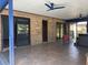 Large patio features brick walls, ceiling fans, sliding glass doors, and tile flooring at 974 Feather Dr, Deltona, FL 32725