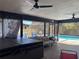 View of covered patio with hot tub, furniture and view of the outdoor swimming pool at 974 Feather Dr, Deltona, FL 32725