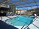 Outdoor swimming pool with screened enclosure, basketball hoop and outdoor seating at 974 Feather Dr, Deltona, FL 32725