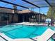 Outdoor swimming pool with screened enclosure, lounge chair, and covered patio at 974 Feather Dr, Deltona, FL 32725