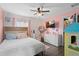 Cozy bedroom with pink walls, ceiling fan, and plenty of storage at 1001 11Th St, St Cloud, FL 34769