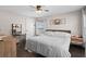 Spacious bedroom with a king-size bed, ceiling fan, and hardwood floors at 1001 11Th St, St Cloud, FL 34769