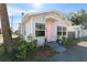Gray house with pink door, landscaping, and sidewalk at 1001 11Th St, St Cloud, FL 34769