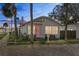 Cute bungalow with pink door, gray siding, and brick pavers at 1001 11Th St, St Cloud, FL 34769