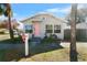 Charming bungalow with pink door and well-manicured lawn at 1001 11Th St, St Cloud, FL 34769