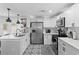 Bright kitchen boasts white cabinets, stainless steel appliances, and patterned floor at 1001 11Th St, St Cloud, FL 34769