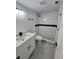 Modern bathroom features white vanity, marble floors, and walk-in shower with black accents at 10232 Turkey Lake Rd # 180, Orlando, FL 32819