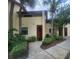 Attractive exterior of home with mature landscaping and sidewalk leading to front door at 10232 Turkey Lake Rd # 180, Orlando, FL 32819