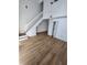 Bright living room with new wood floors, white walls and a stairway at 10232 Turkey Lake Rd # 180, Orlando, FL 32819