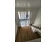 Bright, open living space with wood floors, and stairs to loft area at 10232 Turkey Lake Rd # 180, Orlando, FL 32819