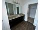 Bathroom with vanity, mirror, and walk-in closet at 1075 Aerides Way, Davenport, FL 33837