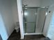 Bathroom with shower stall and wood-look flooring at 1075 Aerides Way, Davenport, FL 33837