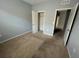 Simple bedroom with carpeted floor and double door closet at 1075 Aerides Way, Davenport, FL 33837