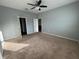 Spacious Primary bedroom with carpet and ceiling fan at 1075 Aerides Way, Davenport, FL 33837