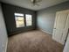 Bright bedroom with neutral walls and carpet at 1075 Aerides Way, Davenport, FL 33837
