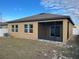 Tan house exterior with screened patio at 1075 Aerides Way, Davenport, FL 33837