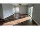 Spacious living room with dark wood flooring and sliding glass doors at 1075 Aerides Way, Davenport, FL 33837