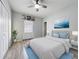 Bright bedroom with a queen-size bed, light wood floors, and large windows at 1109 5Th Sw St, Winter Haven, FL 33880