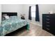 Cozy bedroom with a double bed, dresser, and wood-look floors at 1109 5Th Sw St, Winter Haven, FL 33880