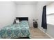 Cozy bedroom with a double bed, dresser, and wood-look floors at 1109 5Th Sw St, Winter Haven, FL 33880