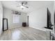 Bright bedroom featuring wood-look floors, a large window, and ceiling fan at 1109 5Th Sw St, Winter Haven, FL 33880