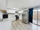 Modern kitchen with white cabinets and stainless steel appliances at 1109 5Th Sw St, Winter Haven, FL 33880