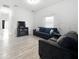 Living room with gray sofas and wood-look floors at 1109 5Th Sw St, Winter Haven, FL 33880