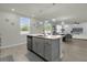 Modern kitchen island with granite countertop and gray cabinets at 144 Towns Cir, Haines City, FL 33844