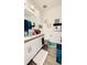 Well-lit bathroom with a white single vanity sink, decorative artwork, and modern wood-look flooring at 15079 Willow Arbor Cir, Orlando, FL 32824