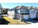 Modern townhome featuring a gray exterior, attached garage, and professionally landscaped yard at 15079 Willow Arbor Cir, Orlando, FL 32824