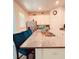 Open kitchen featuring an island with barstool seating, stainless steel appliances, and white cabinets at 15079 Willow Arbor Cir, Orlando, FL 32824