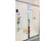 Clean and modern shower with white tile, chrome fixtures, and glass door at 15079 Willow Arbor Cir, Orlando, FL 32824