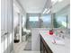 Bathroom with walk-in shower, vanity, and separate toilet at 17863 Passionflower Cir, Clermont, FL 34714