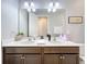 Double vanity bathroom with modern finishes at 17863 Passionflower Cir, Clermont, FL 34714