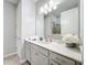 Bright bathroom with white vanity, quartz countertop, and a walk-in shower at 17863 Passionflower Cir, Clermont, FL 34714