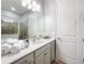 Clean bathroom featuring a vanity with white quartz countertop and a shower stall at 17863 Passionflower Cir, Clermont, FL 34714