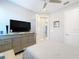 Bedroom with a double bed, dresser, and a large flat-screen TV at 17863 Passionflower Cir, Clermont, FL 34714