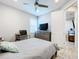 Bright bedroom with a comfortable bed, TV, and ample closet space at 17863 Passionflower Cir, Clermont, FL 34714
