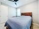 Bedroom with a double bed, ceiling fan, and an armchair at 17863 Passionflower Cir, Clermont, FL 34714