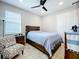 Bedroom with a double bed, ceiling fan, and an armchair at 17863 Passionflower Cir, Clermont, FL 34714