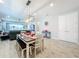 Dining area with wood table and bench seating overlooking the living room at 17863 Passionflower Cir, Clermont, FL 34714